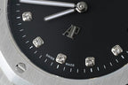 Audemars Piguet black dial wristwatch with diamond hour markers and silver hands