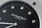 Audemars Piguet black dial wristwatch close-up with diamond markers and silver hands