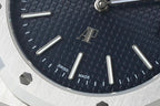 Blue textured watch dial with baton markers, 'SWISS MADE' and date window