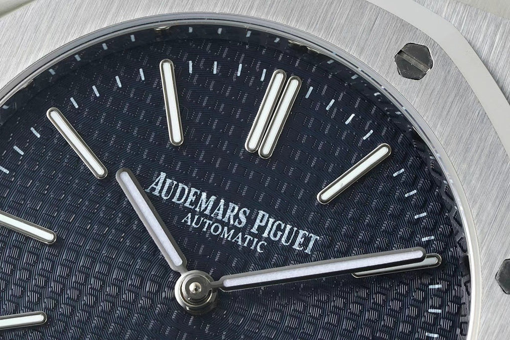 Blue dial watch face with baton hour markers and three prominent hands