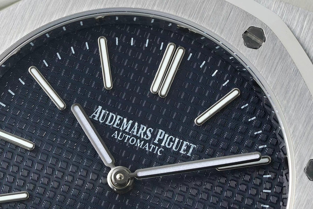 Blue dial watch face with baton hour markers and three prominent hands