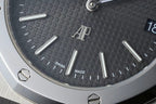 Close-up of dark dial with AU logo and Swiss Made text near markers