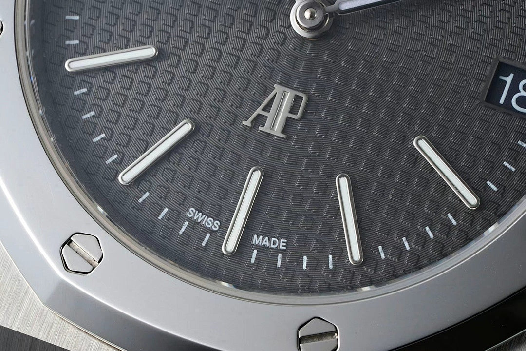 Close-up of dark dial with AU logo and Swiss Made text near markers
