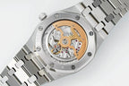 Audemars Piguet watch with exposed mechanical movement, stainless case and metal bracelet
