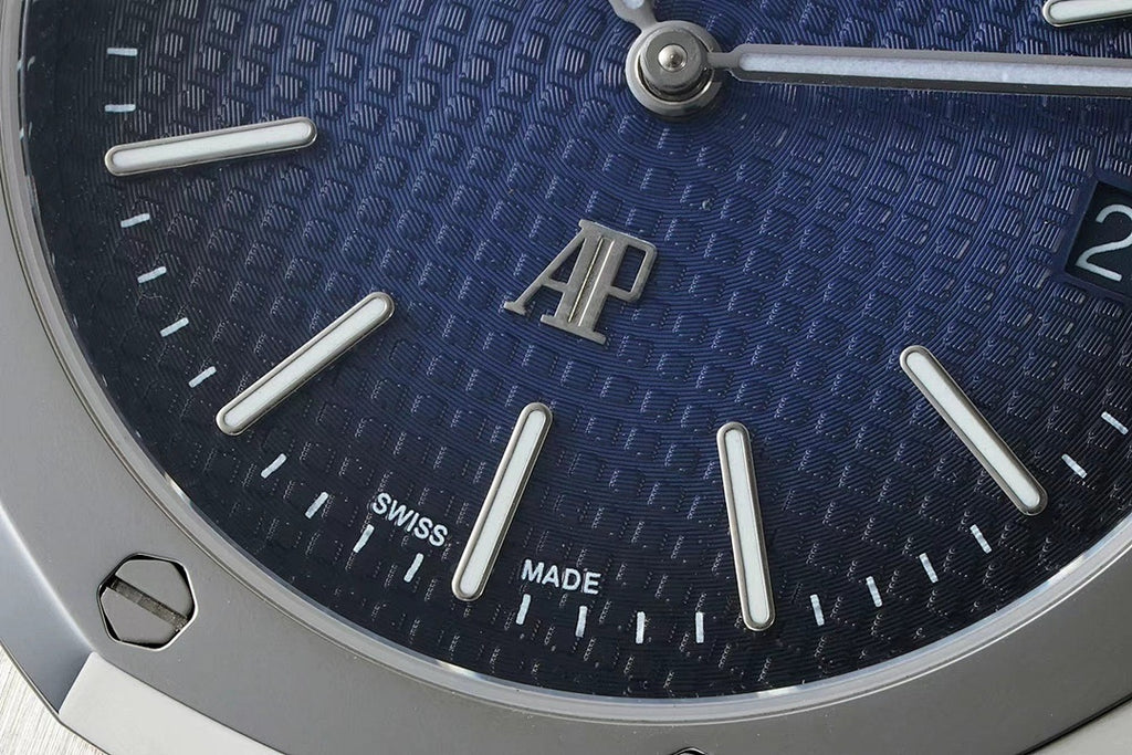 Audemars Piguet watch dial close-up with blue textured pattern, “SWISS MADE” text
