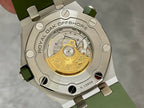 Audemars Piguet watch caseback showing a gold-toned movement on green strap