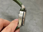 Side view of Audemars Piguet watch with green silicone strap and metal case