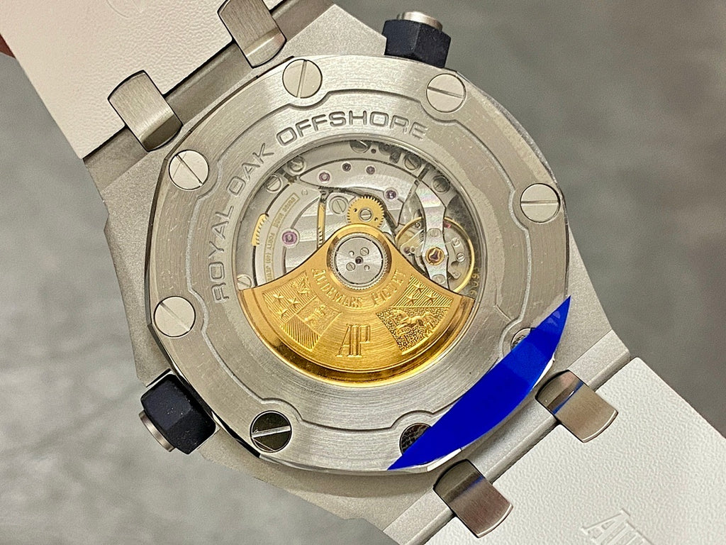Audemars Piguet watch caseback with visible gold-toned movement and rubber strap