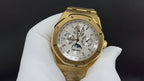 Gold-tone luxury wristwatch with white dial, chronograph subdials, and bracelet