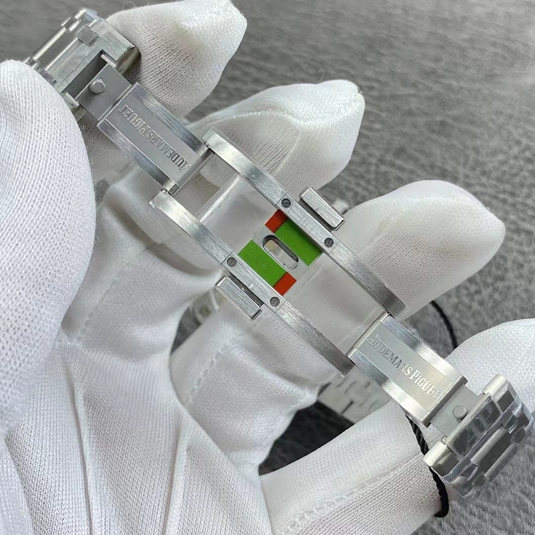 Audemars Piguet watch clasp with silver metal bracelet links and multi-color emblem