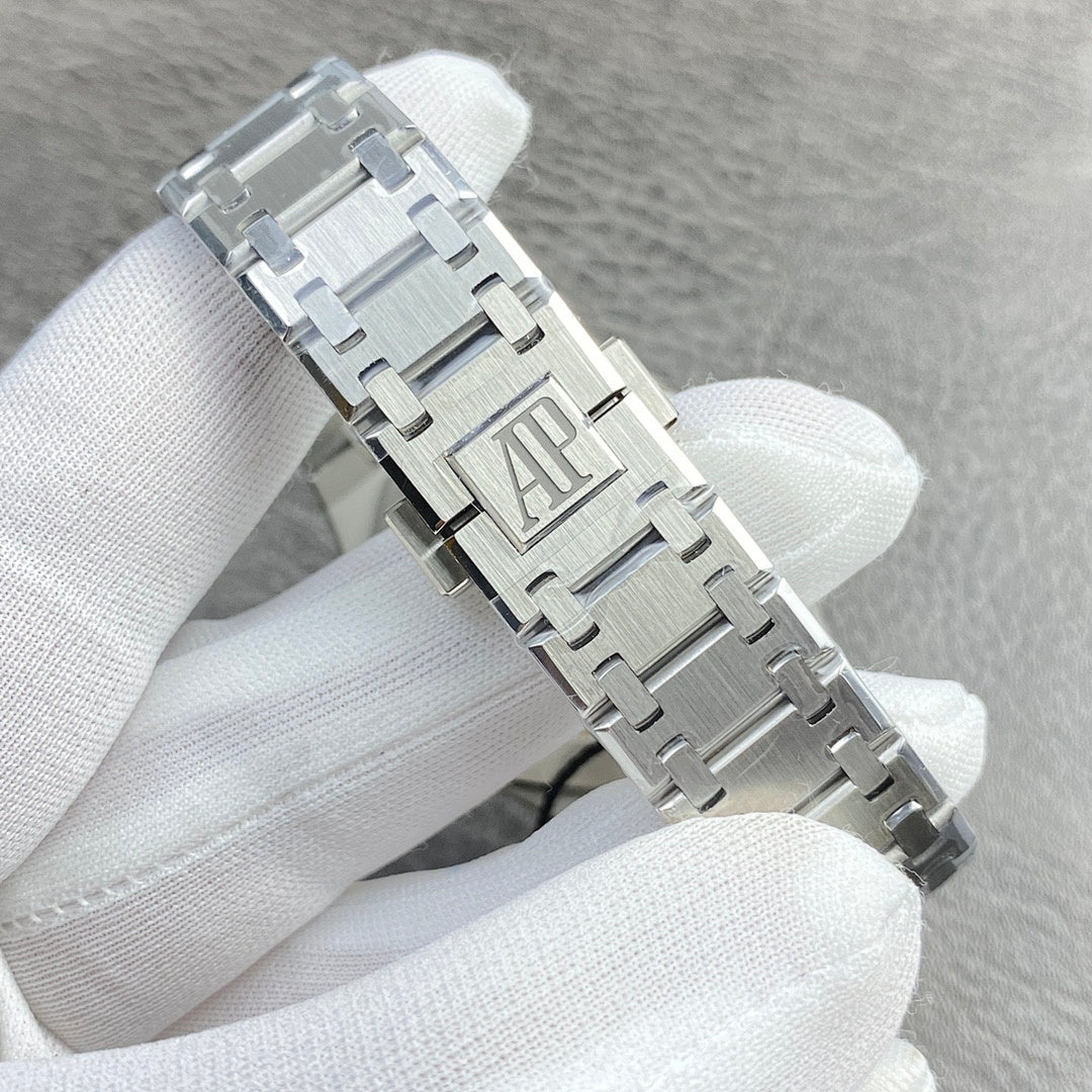 Audemars Piguet watch bracelet close-up with silver clasp and raised link emblem
