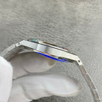 Audemars Piguet watch side view with silver case and blue-toned trim near bezel