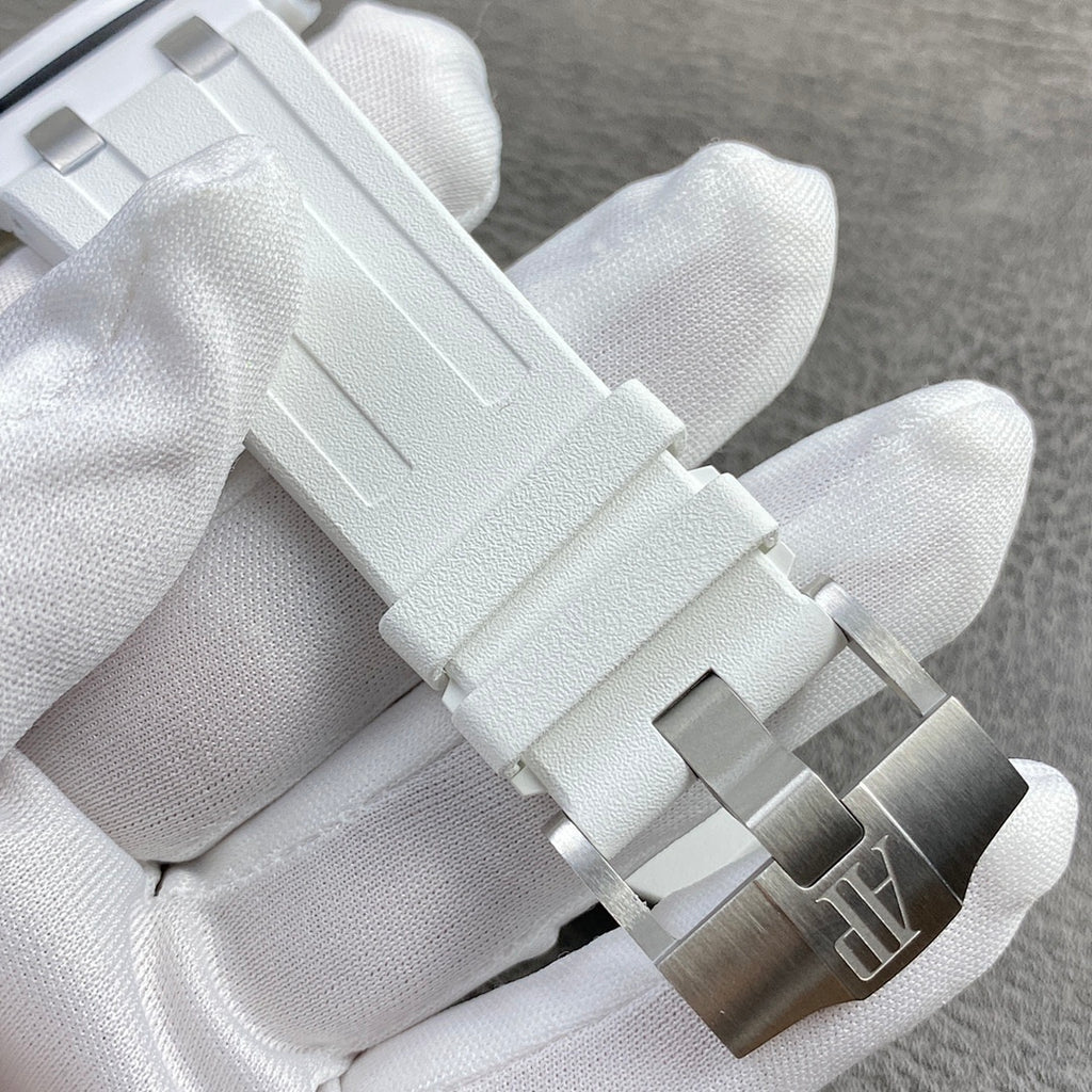 White rubber watch bracelet with metal clasp and brushed silver-toned links.