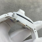 White rubber-cased luxury watch showing crown, side profile, and metal detailing.