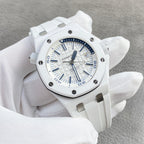 White rubber sports watch with blue indexes, subdials, and black bezel markers.