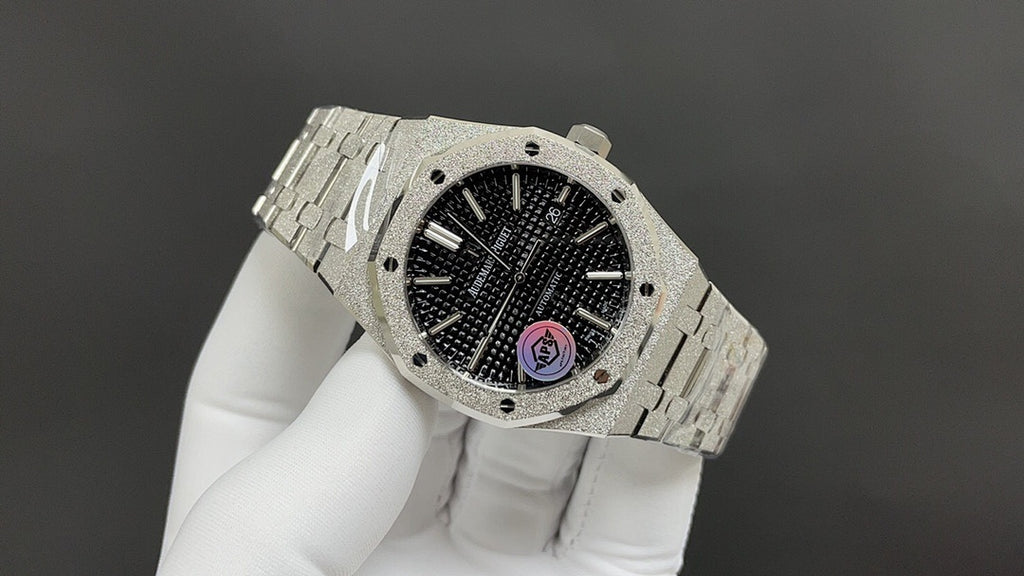 Audemars Piguet watch with black dial and textured center, metal bracelet on white gloves