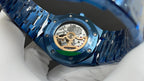 Audemars Piguet watch showing open caseback with gold movement in a blue case
