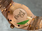 Gold-tone watch caseback with engraved logo and screw details