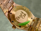 Gold-tone watch caseback with engraved emblems and screw details