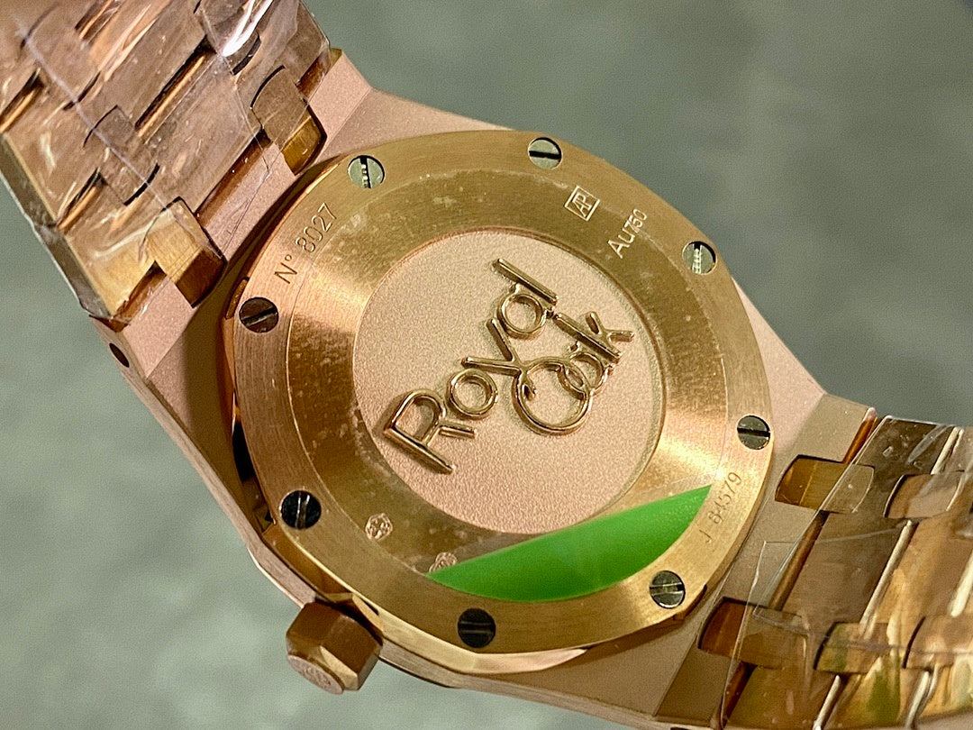 Gold-tone watch caseback with engraved emblems and screw details