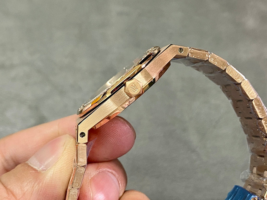 Gold-tone watch side view with crown and metal bracelet links