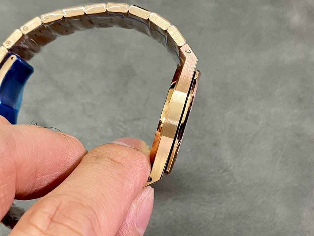 Gold-tone watch side profile with metal bracelet links