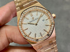 Gold-tone wristwatch close-up with textured dial, diamond bezel, and date display