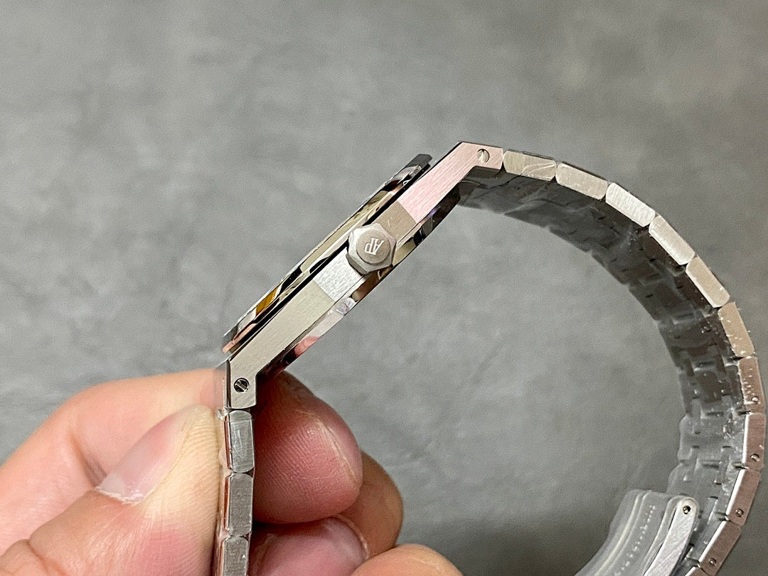 Luxury steel watch case and crown, side profile held by fingers