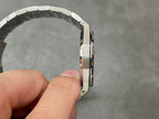 Luxury steel watch case side view with bracelet and clasp edge