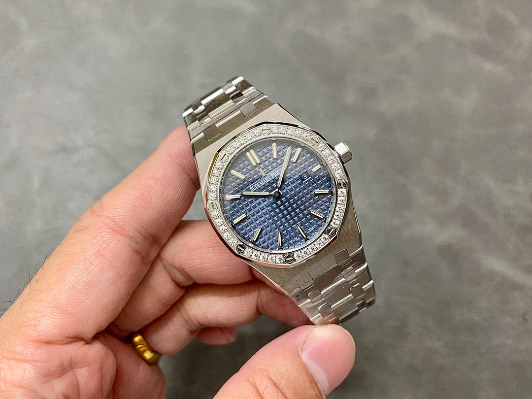 Luxury steel wristwatch with blue textured dial and diamond bezel