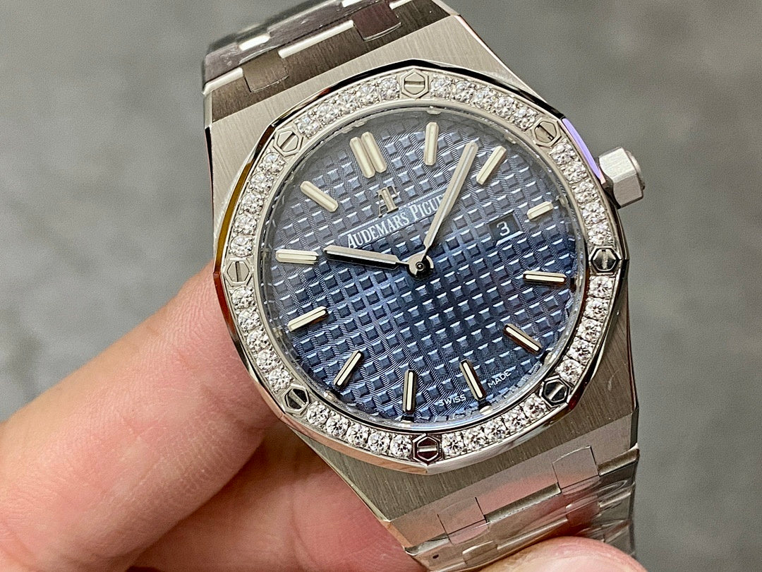 Luxury steel watch with blue dial, gold markers and hands, diamond-set bezel