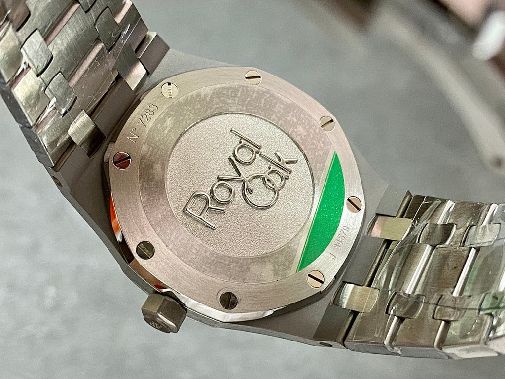 Audemars Piguet watch caseback with engraving and green accent window