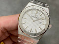 Audemars Piguet Royal Oak wristwatch with white textured dial and gold-tone hands