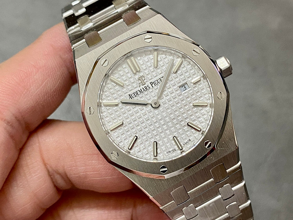 Audemars Piguet Royal Oak wristwatch with white dial, baton markers, and metal bracelet