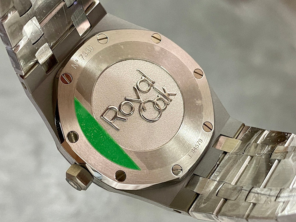Audemars Piguet watch case back with engraved detailing and green stripe accent