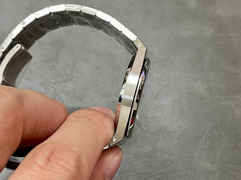 Audemars Piguet watch profile with steel case, crown, and linked bracelet, side view