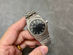 Audemars Piguet watch angled view with black textured dial, steel case and bracelet
