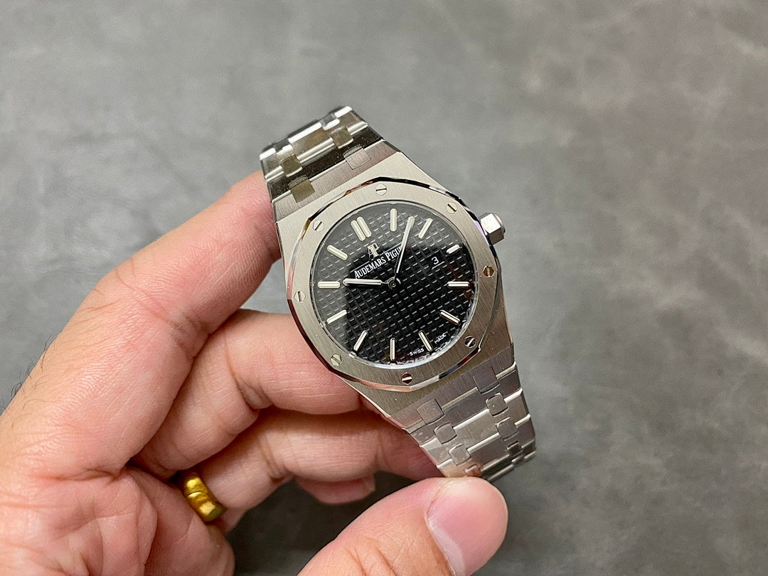 Audemars Piguet watch angled view with black textured dial, steel case and bracelet
