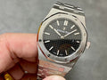 Audemars Piguet watch with black textured dial, steel case and linked bracelet, crown side