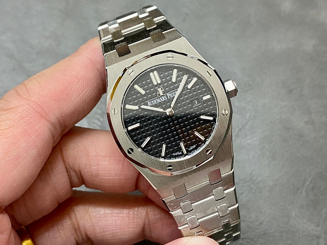 Audemars Piguet watch front close-up with black textured dial, steel bezel and bracelet links
