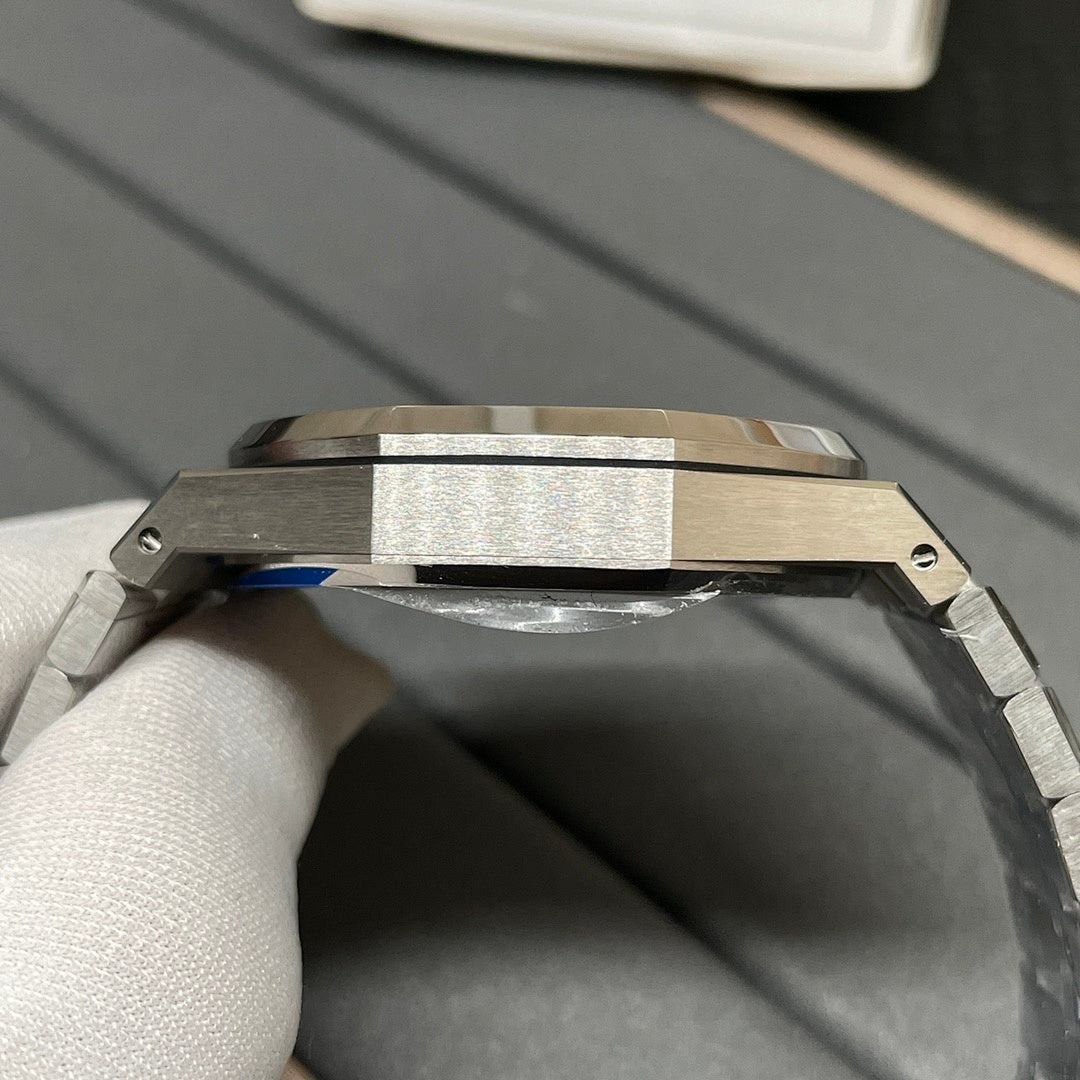 Steel watch case with knurled bezel edge and bracelet links, crown side close view