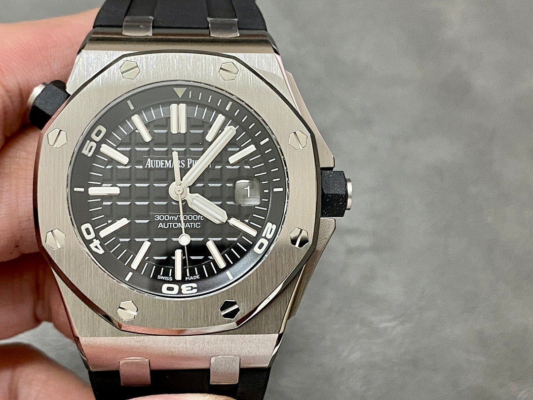 Stainless steel sports watch with black dial and black rubber strap, side view