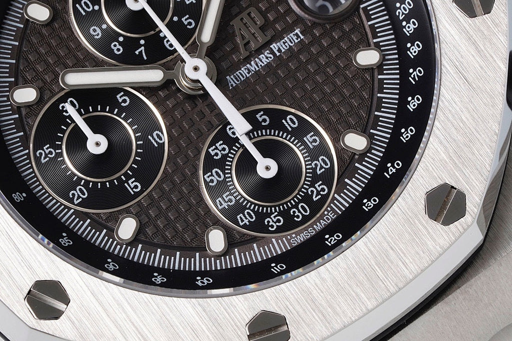 Audemars Piguet watch dial closeup with black tachymeter scale and chronograph hands