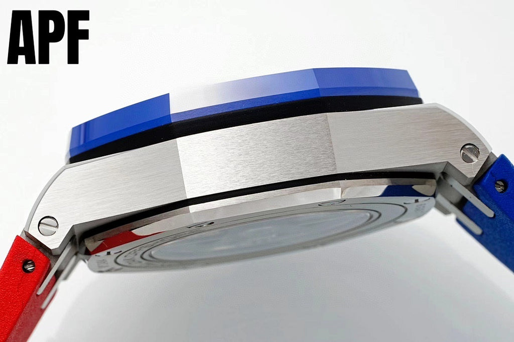 Polished steel watch case back close-up with blue ring and red strap section