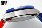 Polished steel watch case back close-up with blue ring and red strap section