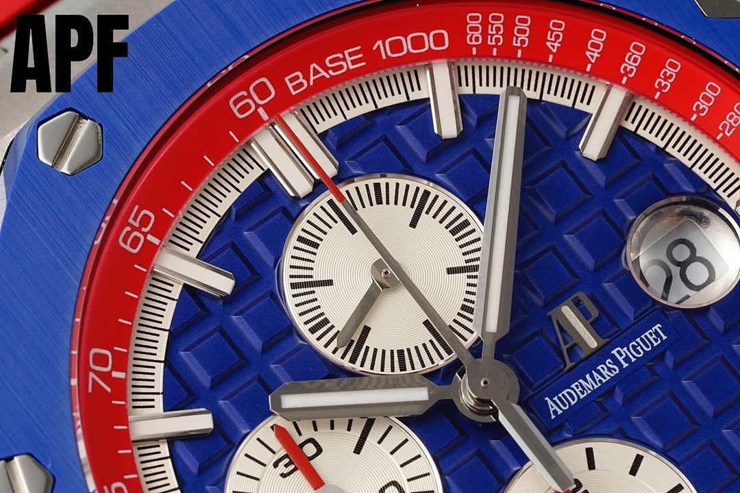 Chronograph watch dial close-up with blue face, white subdials, and red outer bezel