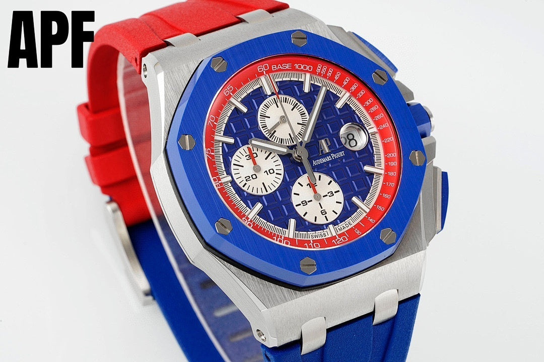 Blue-dial chronograph watch with red bezel, steel case, and red-and-blue silicone strap