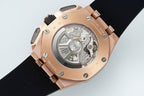 Audemars Piguet watch open caseback with mechanical movement, rose-gold case, black strap.