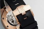 Audemars Piguet watch buckle clasp, rose-gold tone clasp on black rubber strap.
