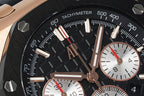Audemars Piguet watch tachymeter ring close-up, black dial with rose-gold hands.